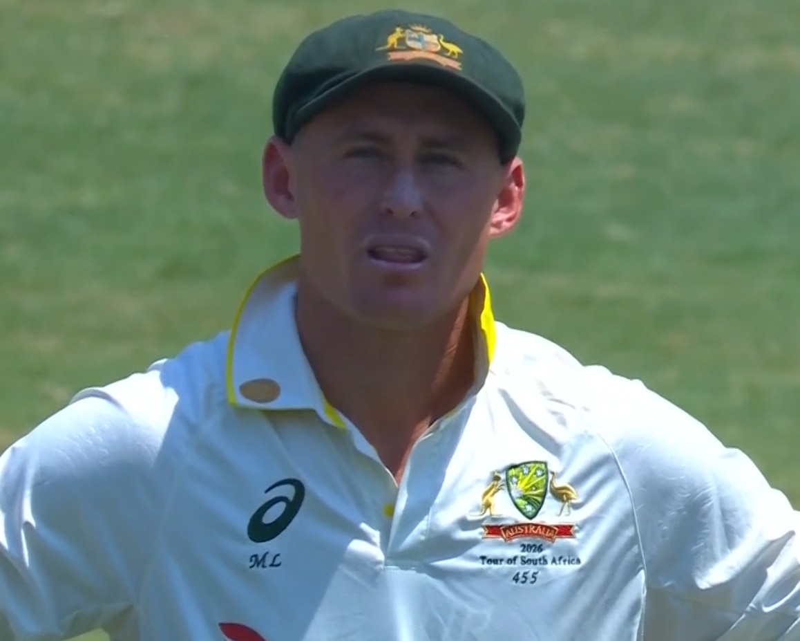A close up shot of a cricketer in a baggy green looking unimpressed.