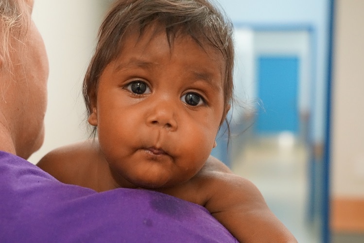 A baby looks into the camera in Lajamanu.