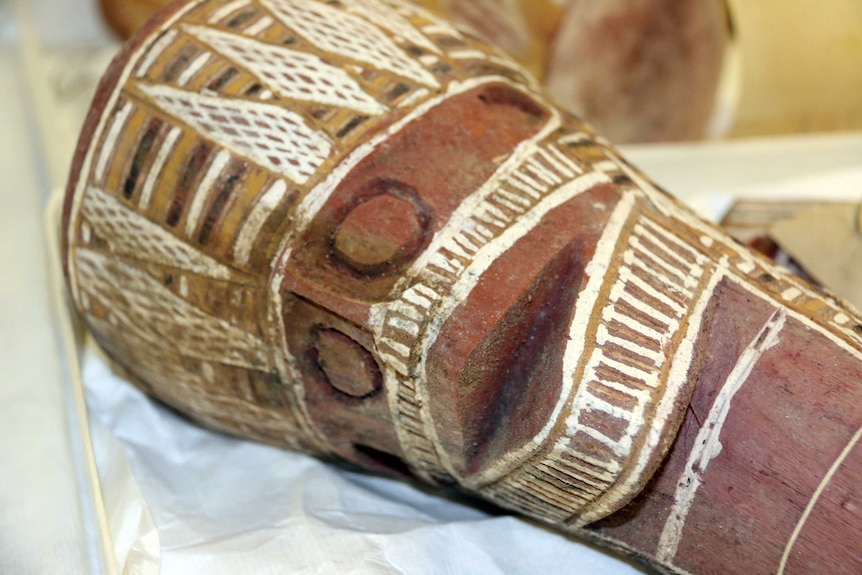 A carved and painted wooden head that was found among the artefacts.