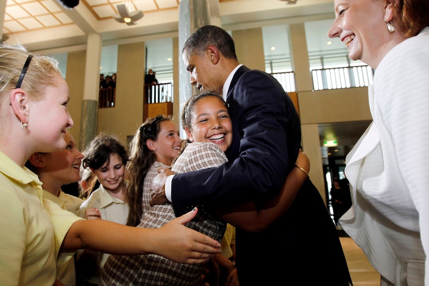 Obama gets a hug from schoolgirl