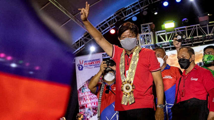 Philippine presidential candidate Ferdinand Marcos Jr. gestures with a victory sign during a campaign rally.