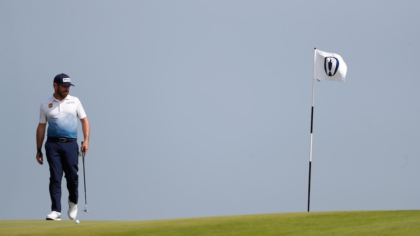 Golfer looking at his putt on the green during a practice round