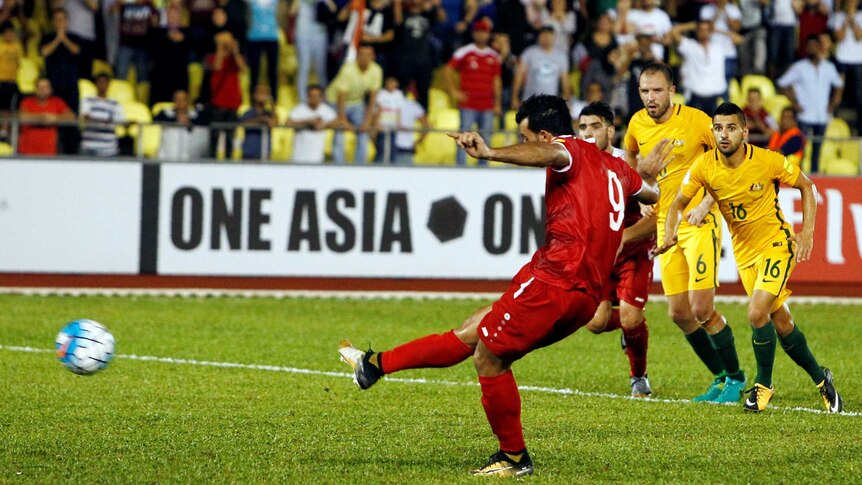 Syria's Omar Al Soma converts a penalty kick