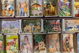 Matchboxes filled with small pictures pasted inside.