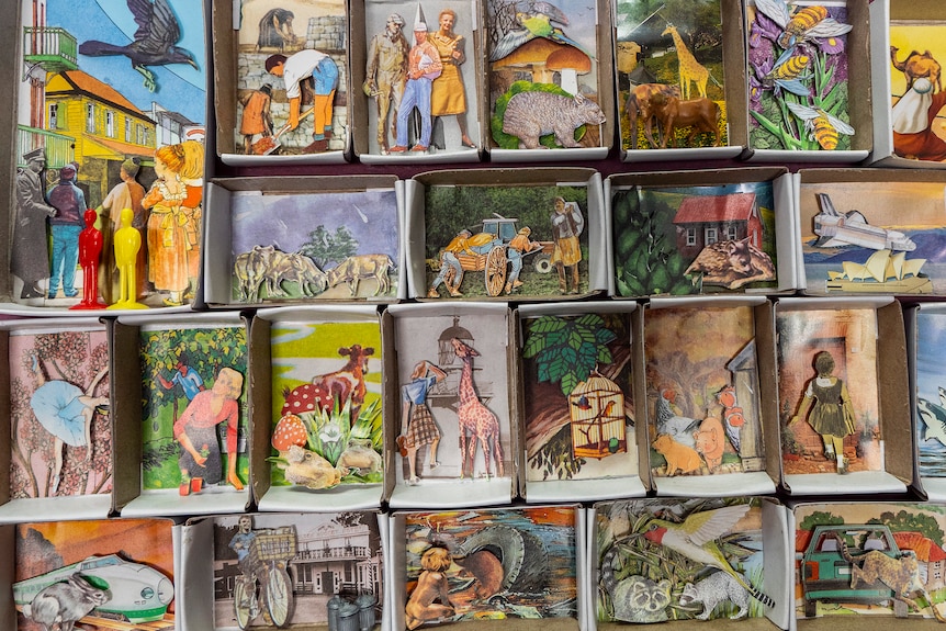 Matchboxes filled with small pictures pasted inside.