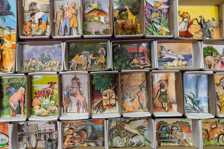 Matchboxes filled with small pictures pasted inside.