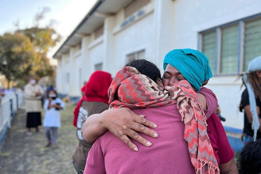 People embrace in Tonga after the volcanic eruption