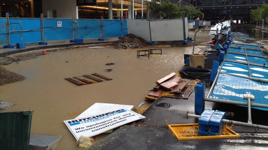 Knocked-over scaffolds and pooling water outside the ABC South Bank building in Brisbane, November 17, 2012.