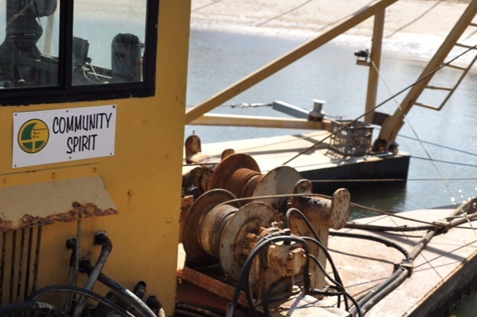 A close up shot of the sign Community Spirit on the dredge