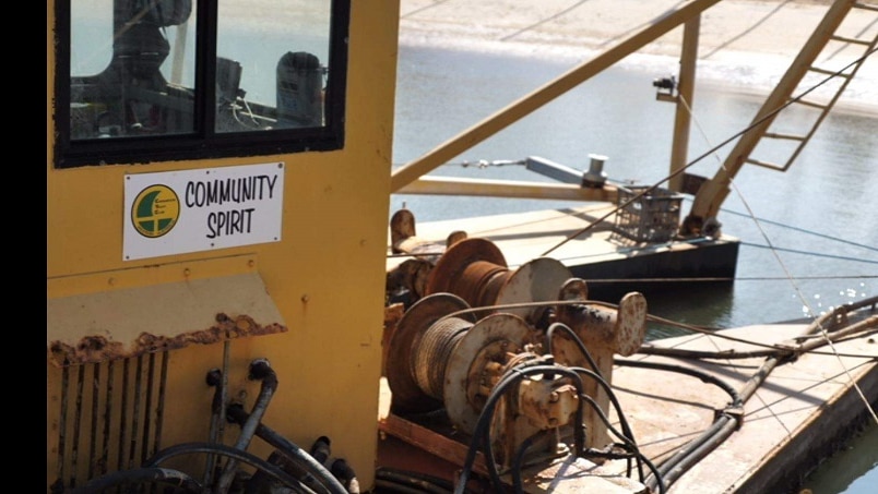 A close up shot of the sign Community Spirit on the dredge