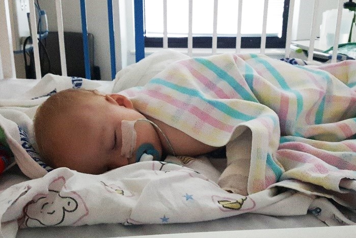 14-month-old Thomas Skrypinski lying down in hospital asleep.