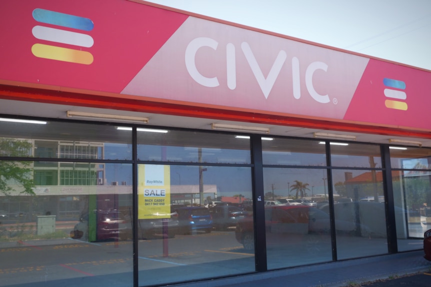 The exterior of an empty video store building