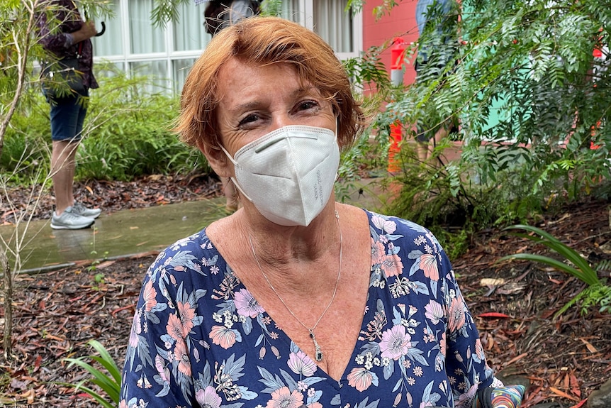 An elderly woman wearing a mask.