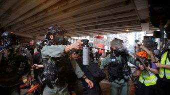Hong Kong police use pepper spray on demonstrators protesting against new national security laws from China.