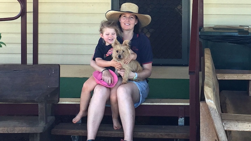 Emily Geiger sitting with her daughter in front of the Eulo General Store