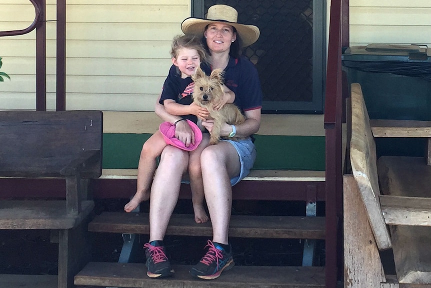 Emily Geiger sitting with her daughter in front of the Eulo General Store