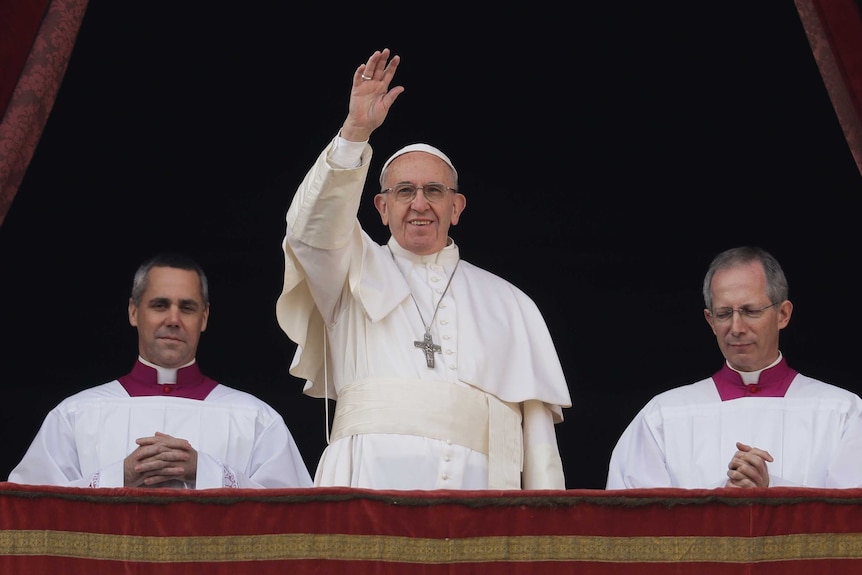Pope Francis stands up and waves