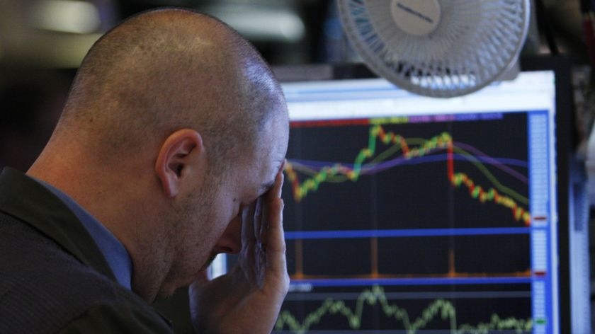 A trader reacts to the monitor shortly before the closing bell as he works on the floor of the New York Stock Exchange