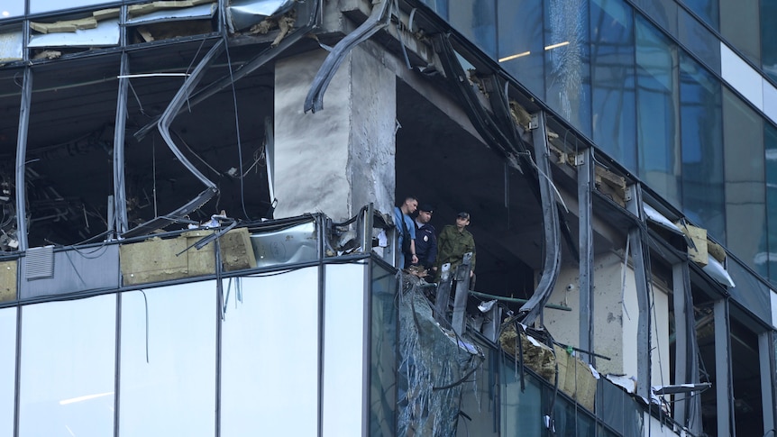 Investigators examine a damaged skyscraper in Moscow.