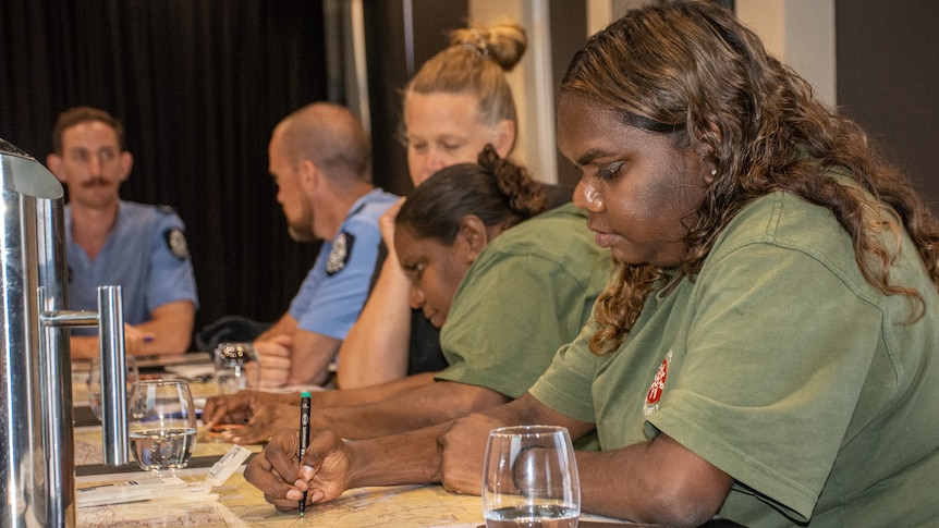 Martu women reading maps.