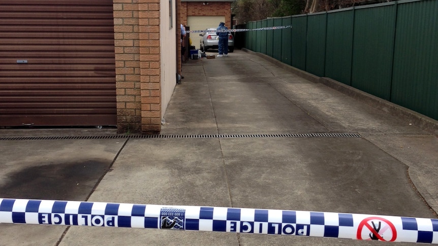 Forensic police at a Revesby home where a couple's bodies were found