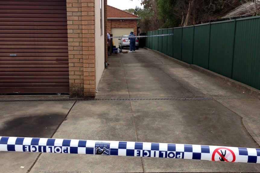 Forensic police at a Revesby home where a couple's bodies were found