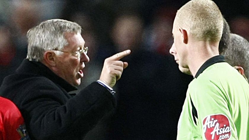 Manchester United manager Alex Ferguson gestures towards referee Mike Dean