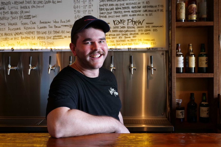 Bar manager Jordan Blackman stands at his bar on Oxford Street, Sydney.