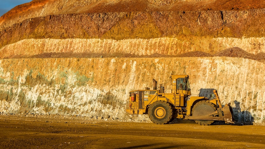 A huge vehicle working at an open cut mine. 