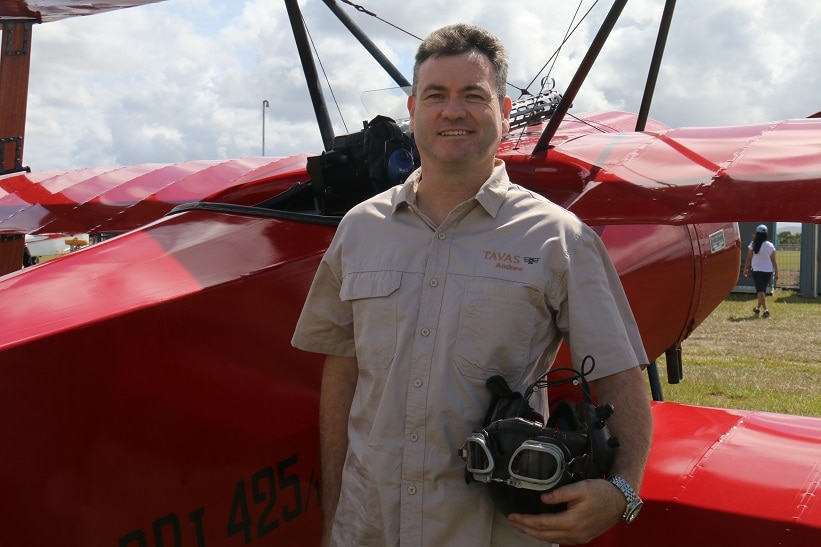 Pilot Andrew Carter next to a replica Fokker DR.1 Triplane.