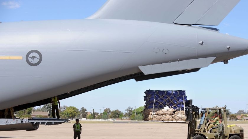 An RAAF C-17 is loaded with supplies