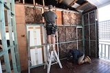 Two unidentifiable people work on a home renovation in Brisbane.
