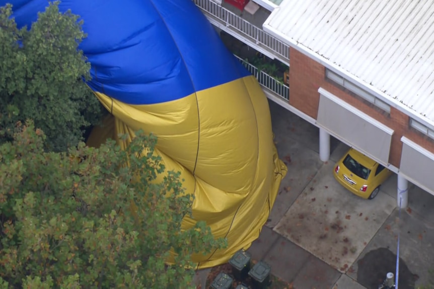 A hot air balloon draped over a crash