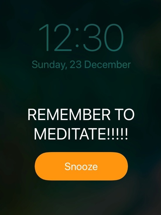 Alarm on phone reminds person to meditate