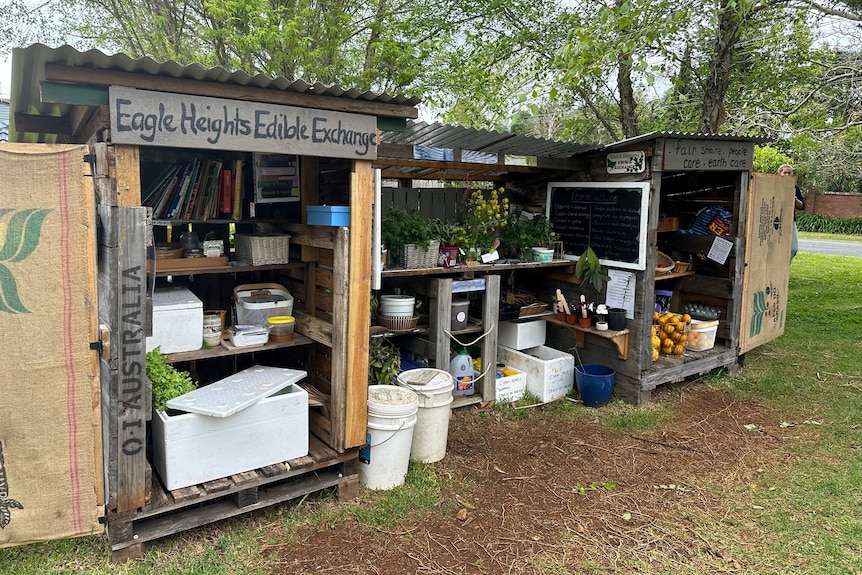 Roadside food stall containing fruit and vegetables.