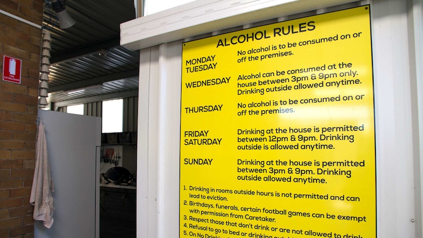 A large yellow sign with black writing spells out rules for drinking