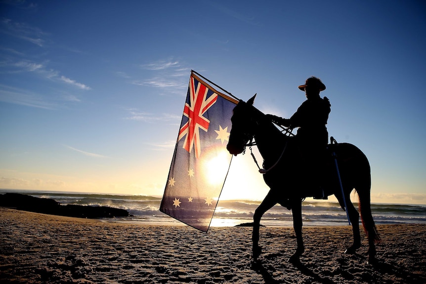 A member of the Mudgeeraba light horse troop takes part in the Anzac Day dawn service at Currumbin.