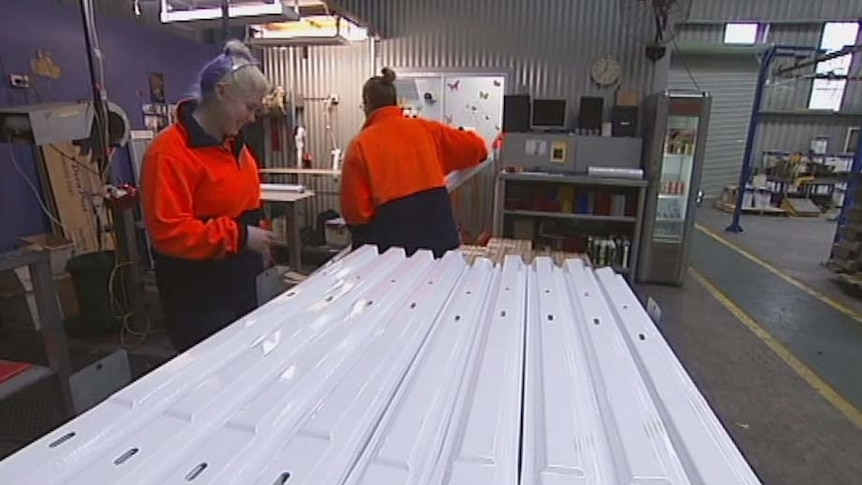 Workers at a road post factory in Launceston.