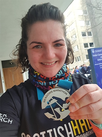 Amy Small with a running medal