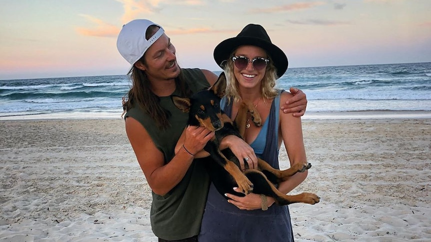 Australian snowboarder and Olympian Alex Pullin with his girlfriend Ellidy Vlug and their dog Rummi on the beach.