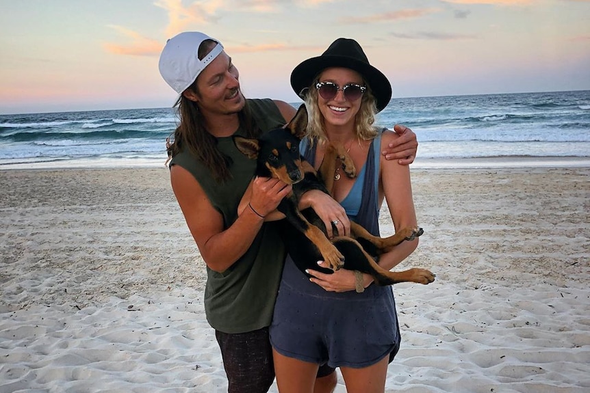 Australian snowboarder and Olympian Alex Pullin with his girlfriend Ellidy Vlug and their dog Rummi on the beach.