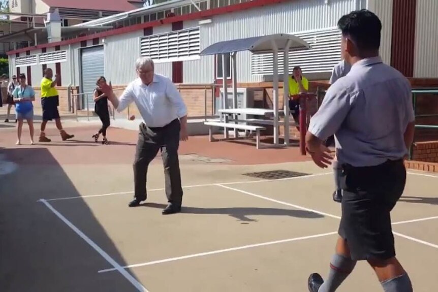 Former PM Kevin Rudd playing handball with year 12 students in Kelvin Grove.