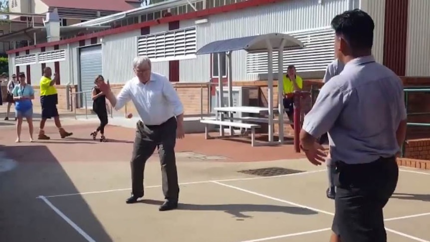 Former PM Kevin Rudd playing handball with year 12 students in Kelvin Grove.