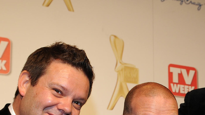 Gary Mehigan, George Calombaris and Matt Preston smile while holding a silver Logie.