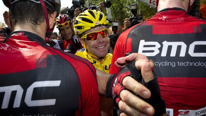 Australian overall leader Cadel Evans (C) celebrates with BMC team-mates on the Champs Elysees.