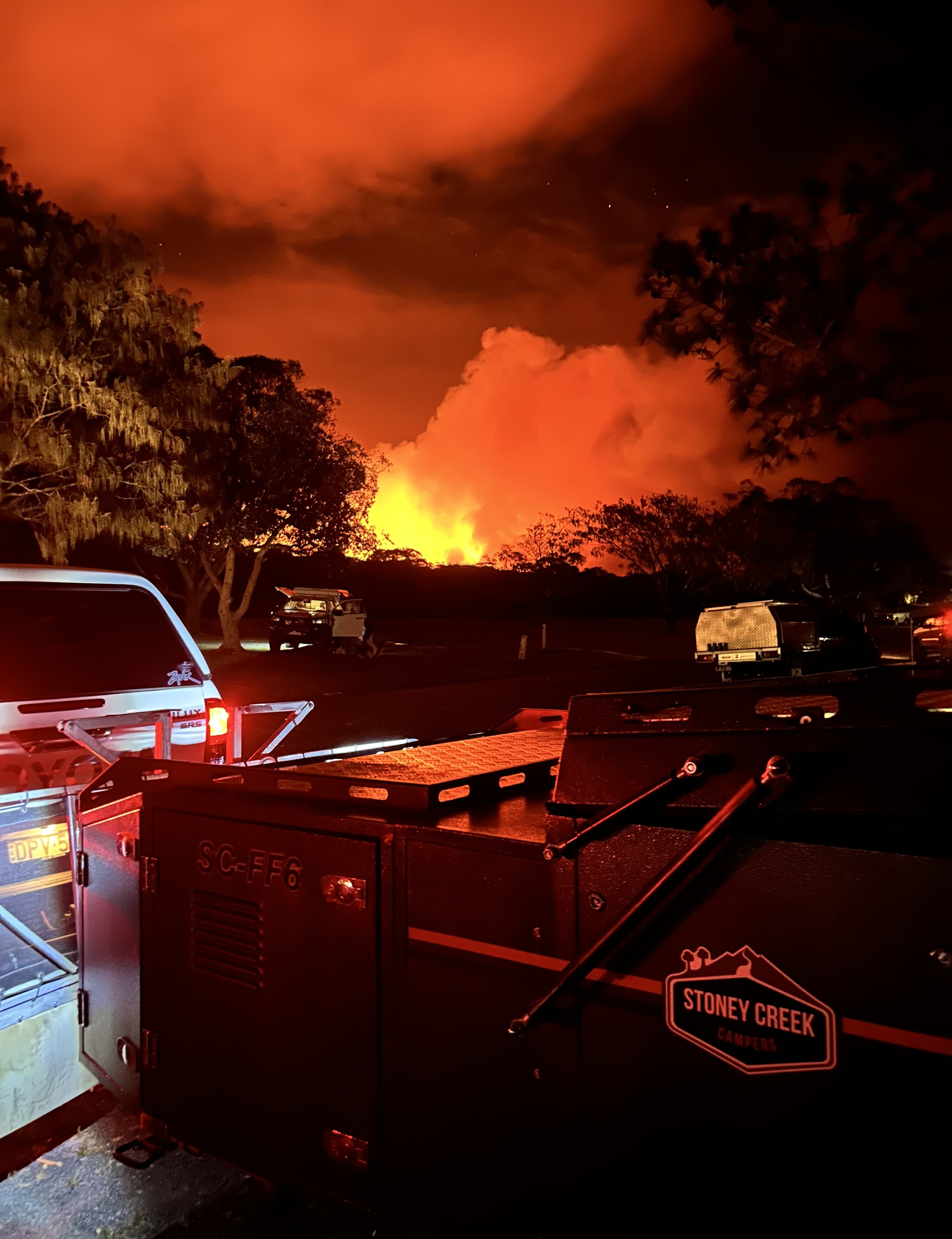 raging fire over a hill at night