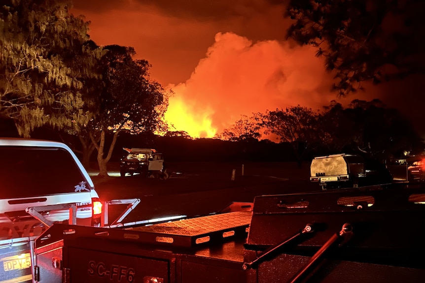 raging fire over a hill at night