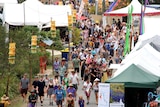 The crowd make their way through some of the stalls at the Woodford Folk Festival.
