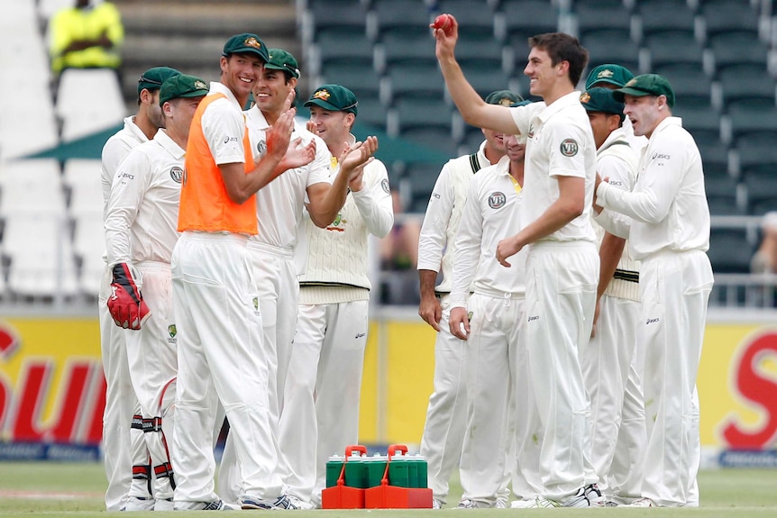 Pat Cummins holds the ball up to the crowd during his Test debut in Johannesburg in 2011.