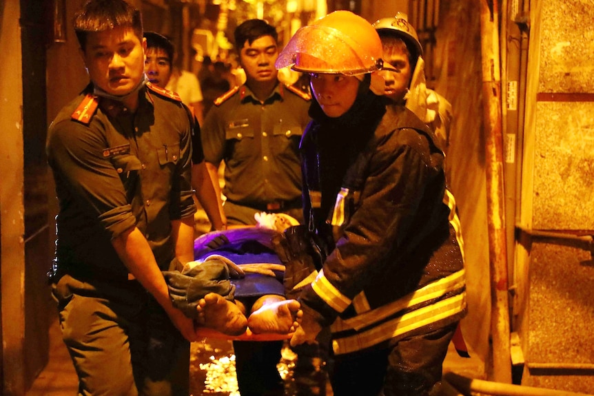 Rescue workers carry a victim on a stretcher